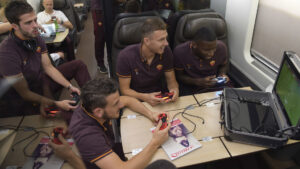 ROME, ITALY - OCTOBER 24: AS Roma players Miralem Pjanic (L) Edin Dzeko, Antonio Rudiger and Alessandro Florenzi having fun with videogames on their way to Florence on October 24, 2015. (Photo by Luciano Rossi/AS Roma via Getty Images)