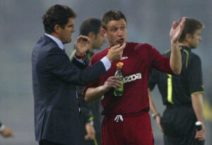 ROME, ITALY - MARCH 21: AS Roma coach Fabio Capello (L) talks with Antonio Cassano during the Serie A match between Roma and Lazio at the Stadio Olimpico on March 21, 2004 in Rome, Italy. The Game was abandoned after half-time after crowd trouble, with the score at 0-0. (Photo by New Press/Getty Images)