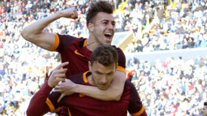 UDINE, ITALY - MARCH 13: Edin Dzeko #9 of AS Roma celebrate with his team's mate Stephan El Shaarawy (up) after scoring his opening goal during the Serie A match between Udinese Calcio and AS Roma at Stadio Friuli on March 13, 2016 in Udine, Italy. (Photo by Dino Panato/Getty Images)
