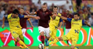 ROME, ITALY - OCTOBER 18: Radja Naiggolan (C) of AS Roma competes for the ball with AC Chievo Verona players during the Serie A match between AS Roma and AC Chievo Verona at Stadio Olimpico on October 18, 2014 in Rome, Italy. (Photo by Paolo Bruno/Getty Images)