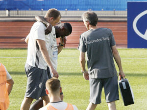 Antonio Ruediger is led off the pitch after he was injured during a training session of the German team in the Camille Fournier stadium at their base camp in Evian, France, Tuesday, June 7, 2016. Germany will face the Ukraine in a Euro 2016 Group C soccer match in Lille on Sunday, June, 12, 2016. (AP Photo/Michael Probst)
